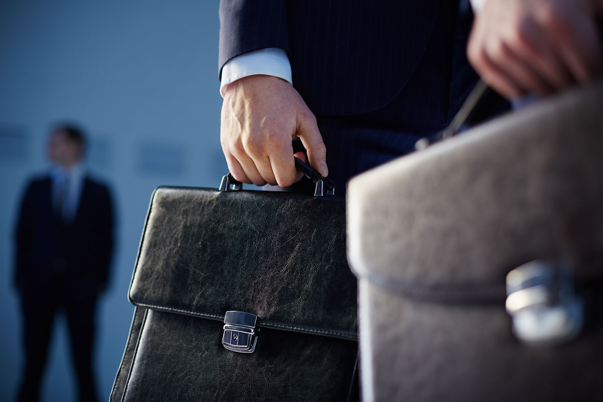 close-up-of-workers-with-briefcases
